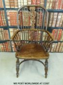 An elm and oak hoop back Windsor chair with pierced splat back