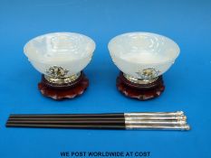 A pair of Chinese hardstone bowls with gilt and white metal mounts on hardwood stands together with