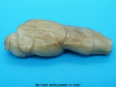 A Chinese jade figure of a sage with russet inclusions (8cm long)