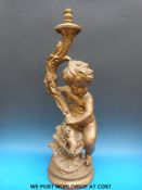 A painted lamp in the form of a putti (height 73cm)