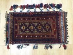 An Afghan rug with geometric design,