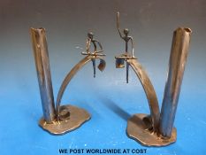 A pair of blacksmith made contemporary metal candlesticks decorated with two seated figures (height