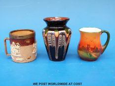 A miniature Royal Doulton Lambeth mug with silver hallmarked top together with a miniature hand