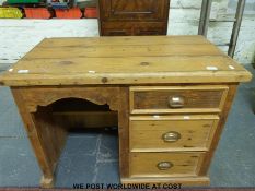 A pine single pedestal desk (W101cm D56cm H75cm)