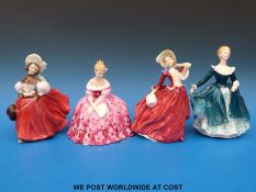 Four Royal Doulton figures to include Autumn Breezes, The Skater and Victoria,