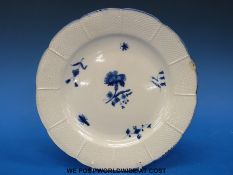 A late 18thC Chantilly plate decorated with blue and white floral sprays (diameter 24cm)