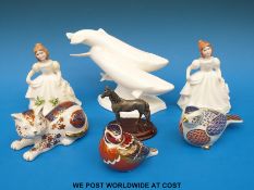 Three Crown Derby paperweights (two birds and a cat), two Royal Doulton ladies,