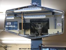 An Art Deco mirror with stylised finial and bevelled glass in silver plate surround