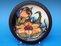 A Moorcroft dish in Lily pattern on a blue and white ground,