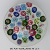 Clichy spaced millefiori glass paperweight with 38 various canes on a white ground.