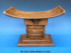 A hand carved 19th/20thC African Ashanti head rest/ pillow with added finish and stepped base