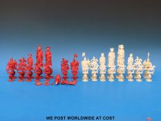 A 19thC Chinese ivory puzzle ball chess set, one side stained red,