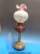 A 19th/early 20thC oil lamp with wrythen column and cut glass reservoir