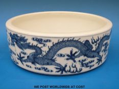 A 20th Chinese blue and white cylindrical bowl with dragon chasing flaming pearl decoration (24.