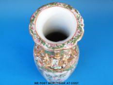 A Chinese famille rose vase enamelled and gilt decorated with figural scenes (26cm tall)