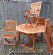 An octagonal teak extending garden table and four chairs.