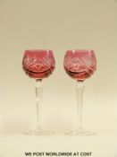 Pair of flash overlaid cranberry hock glasses with cut decoration on hexagonal stems,