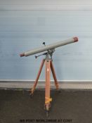 A vintage astronomical telescope on a wooden tripod