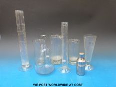 A quantity of glass measuring laboratory/medical jugs etc together with a glass spirit lamp,