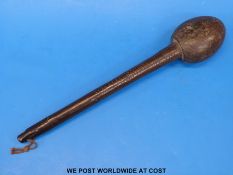 A 19thC war club with various indentations to shaft,