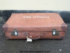 A vintage leather suitcase with reinforced corners