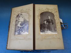 A leather-bound and clasped Victorian photograph album full of interesting family photographs,