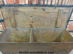 An antique elm dough bin with hinged lid, raised on turned legs united by moulded stretchers (H76,