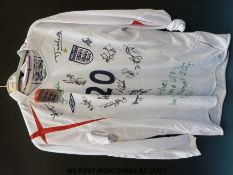 An England football shirt signed by 15 of the U21 team in 2005 together with three England t-shirts
