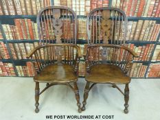 A near pair of elm seated hoop back Windsor chairs with pierced splat backs and crinoline stretcher