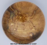 A 19thC glass paperweight with embossed gilt scene in the form of five men around a table in a