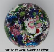 Clichy scrambled glass paperweight with various multicoloured canes, one featuring the letter 'C',