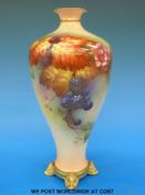 A Royal Worcester and James Hadley footed vase hand-decorated with berries and autumn leaves,