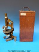 A cased 19thC brass microscope by Ernst Leitz Wetzlar with an 1895 presentation plaque attached to
