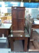 A glass topped coffee table and a pot cupboard