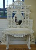 A Victorian possibly Coalbrookdale cast iron hall or conservatory table with oval mirror to back