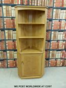 An Ercol double height corner cabinet in light elm (height 180cm)