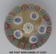 Baccarat spaced millefiori glass paperweight with central green and white cane surrounded by a ring