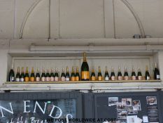 Twenty five  dummy champagne bottles (above door)