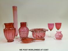 A collection of cranberry glass to include an enamelled vase, a Mary Gregory vase,