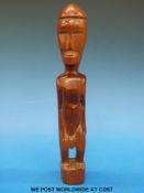A wooden ancestor figure possibly from the Fimor tribe,