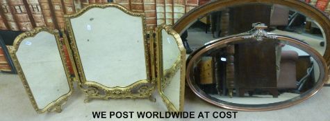 An oval brass framed bevelled glass mirror and a folding mirror