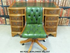 A reproduction twin-pedestal desk (width 119cm) and chair