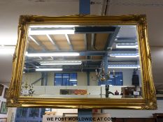 A rectangular gilt framed mirror with bevelled glass moulded decoration,