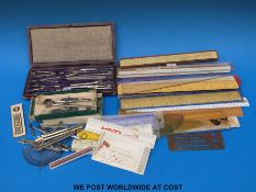 A collection of slide rules and drawing equipment together with a cased drawing set