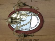 A Murano style cut glass, velvet framed mirror with two sconces,