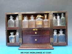 A Georgian mahogany medicine cabinet with two pull out drawers, probably by Shringweiler & Co.