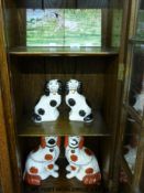 A 19thC Staffordshire spill vase in the form of a dog and further Staffordshire style dogs,