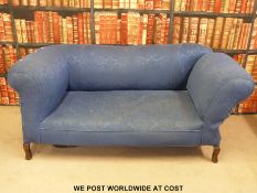 A beige and red upholstered sofa with drop end together with another drop end sofa