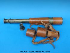 A three drawer brass telescope with leather casing and spare 15 x eyepiece (also cased) with