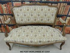 A two seat sofa with carved frame